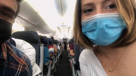 Kara Bass and Guillermo Rojer seated separately on the flight
