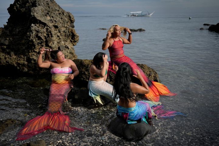 Queen Pangke Tabora, right, and her students prepare for a mermaiding class at the Ocean Camp in Mabini, Batangas province, Philippines on Sunday, May 22, 2022. (AP Photo/Aaron Favila)