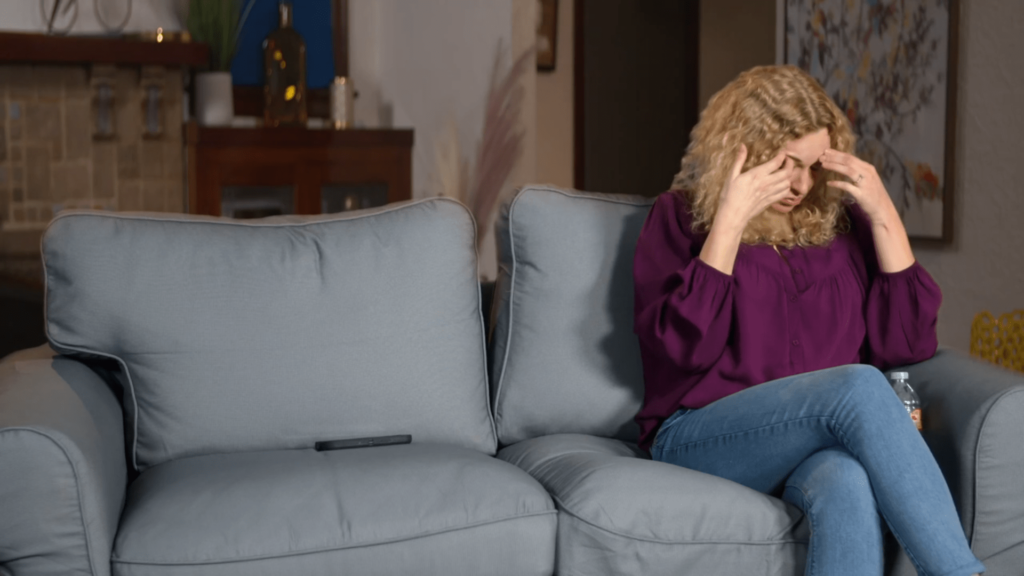 Natalie Mordovtseva sits alone on the couch