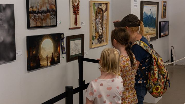 Fairgoers check out Allen's winning artwork in Pueblo, Colorado.