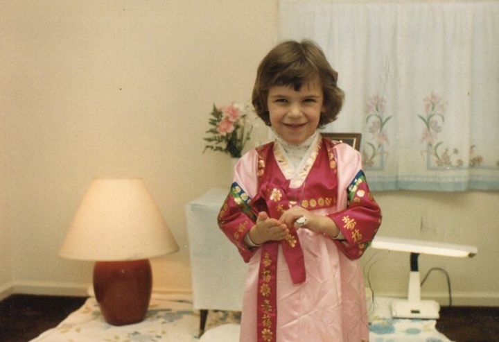 The author as a child participating in an "Eight Day Ceremony" for her brother, during which he was dedicated to God.