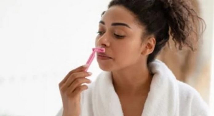 Lady shaving her face