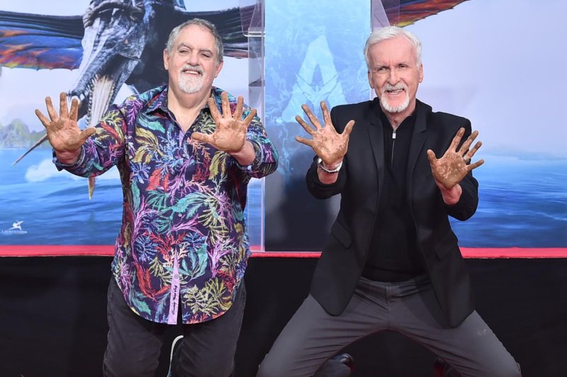 Jon Landau (L) and James Cameron show off their handprints. Photo courtesy of Getty Images for 20th Century Studios