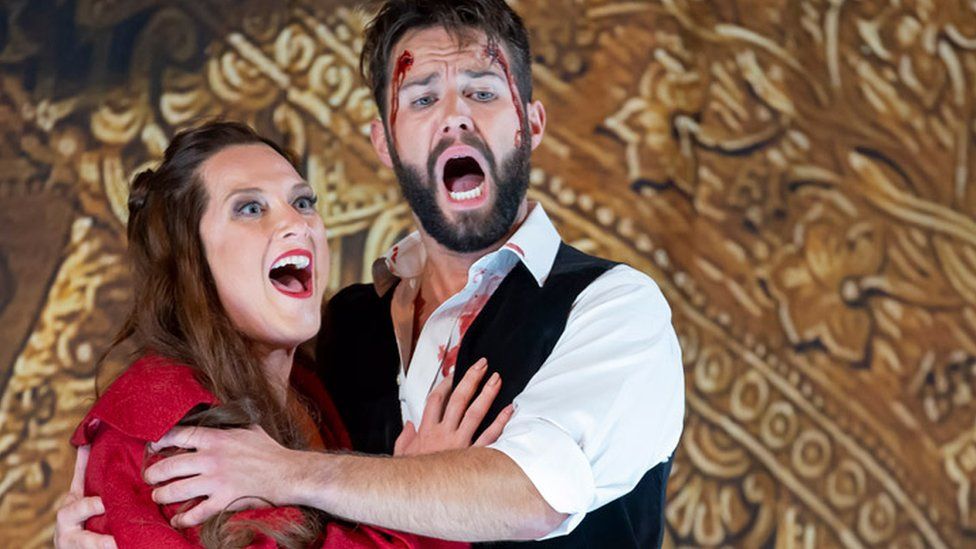 Sinead Campbell-Wallace as Floria Tosca and Adam Smith as Matio Scarpia perform onstage during a production of Tosca by Giacmo Puccini at London Coliseum on September 28, 2022 in London, England.