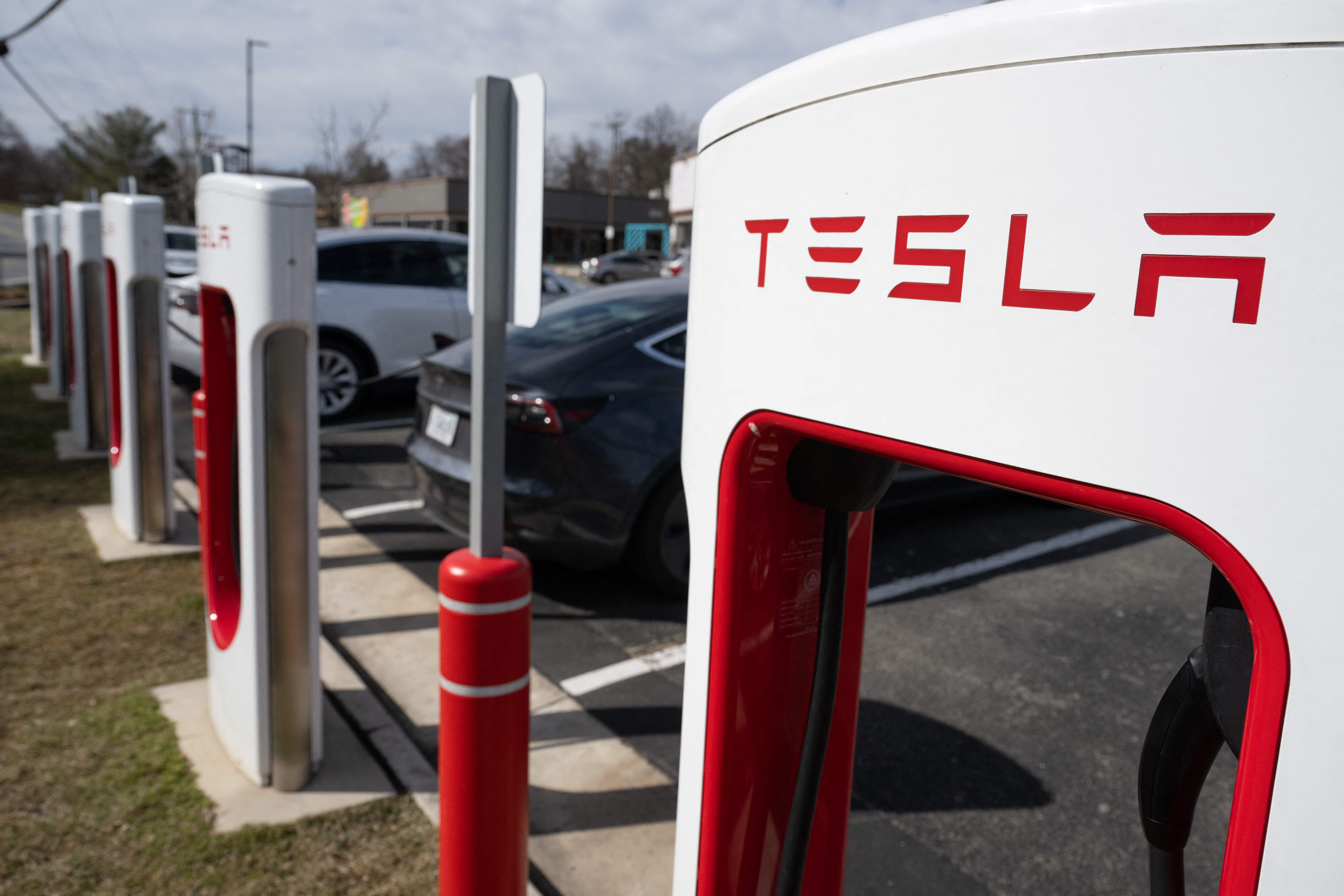 Teslas charging at Superchargers