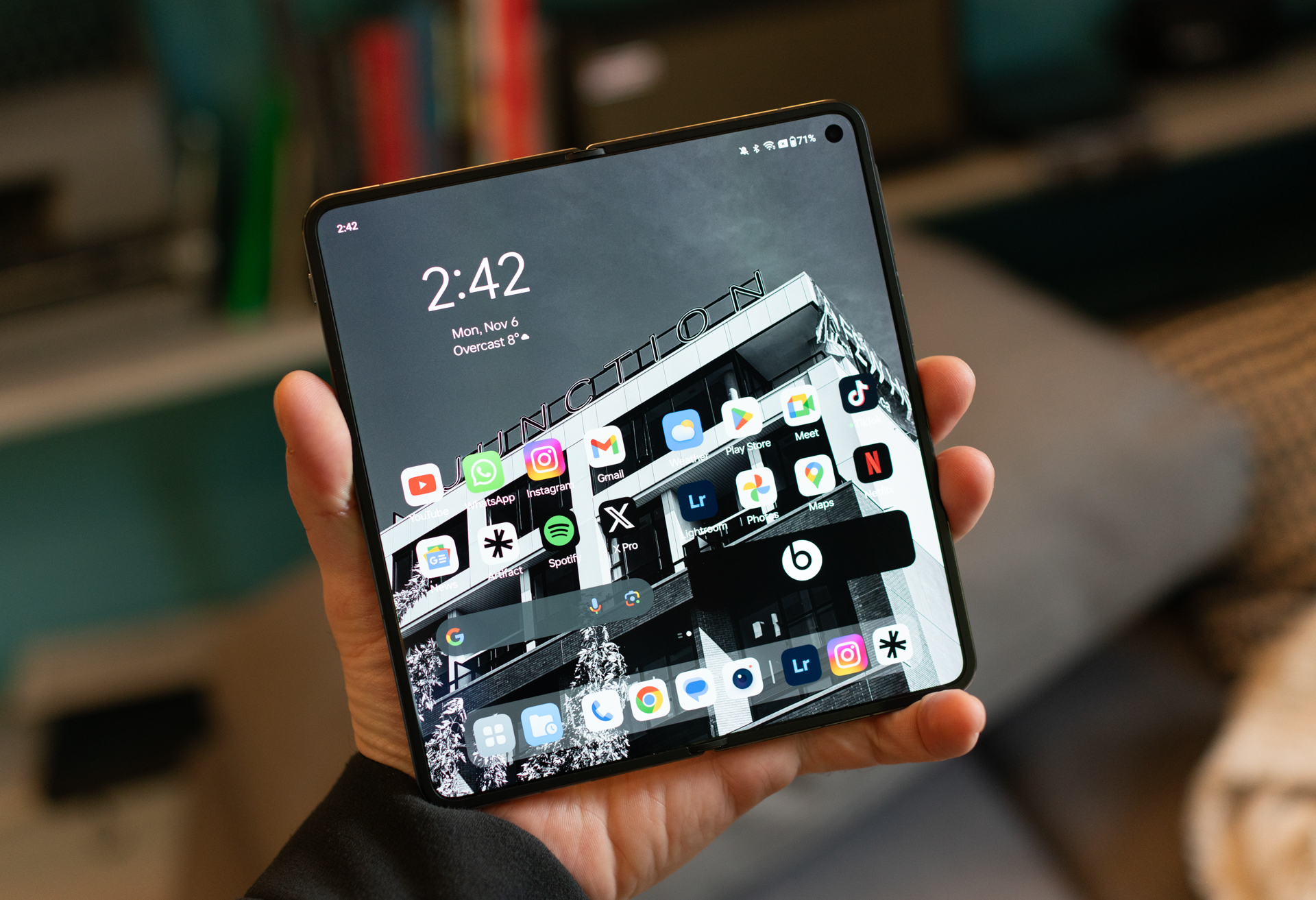 OnePlus Open held open in a hand with the internal display facing the camera