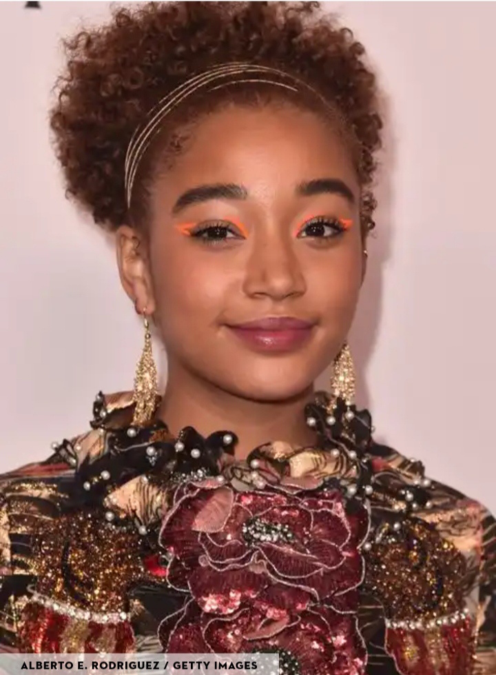 Natural hair with moving on top hairstyle.