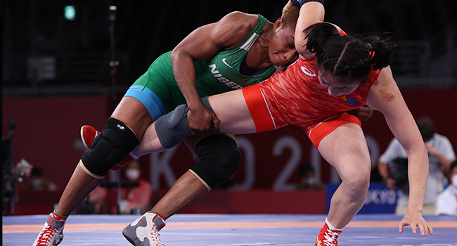 Nigeria's Blessing Oborududu (blue) wrestles Mongolia's Battsetseg Soronzonbold in their women's freestyle 68kg wrestling semi-final match during the Tokyo 2020 Olympic Games at the Makuhari Messe in Tokyo on August 2, 2021. Jack GUEZ / AFP