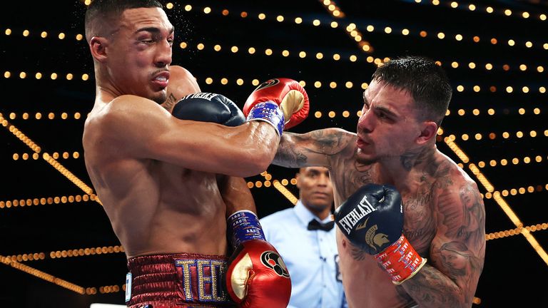 George Kambosos Jr. punches Teofimo Lopez during their bout for title of Undisputed Lightweight Champion
