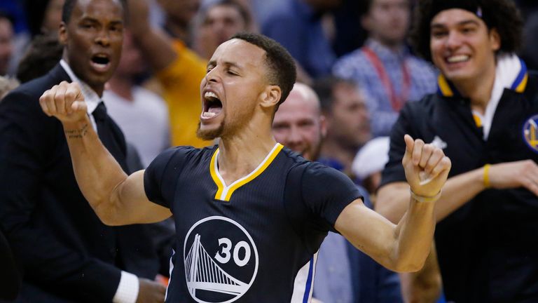 Golden State Warriors guard Stephen Curry celebrates after hitting the game-winning shot in overtime of an NBA basketball game against the Oklahoma City Thunder