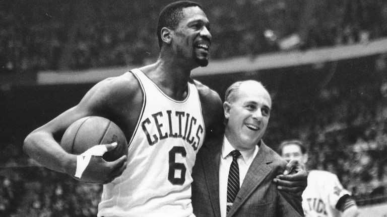 Bill Russell, left, star of the Boston Celtics is congratulated by coach Red Auerbach after scoring his 10,000th point in the NBA game against the Baltimore Bullets in Boston in December 1964