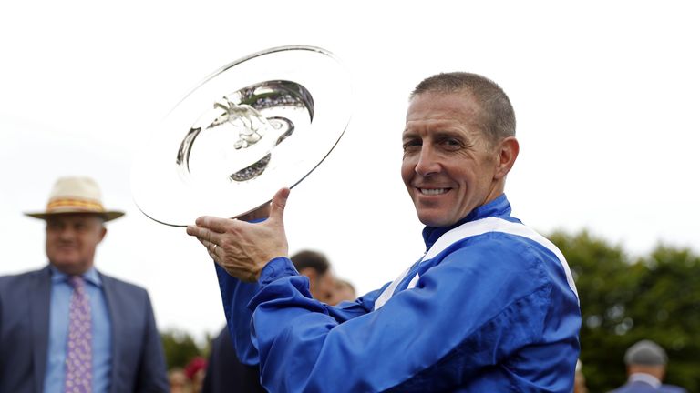Jim Crowley lifts the Sussex Stakes trophy after victory on Baaeed
