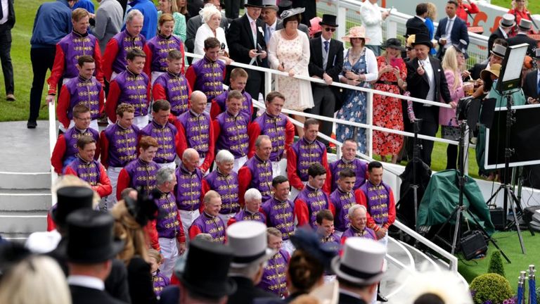 Jockeys pose for a special photo at Epsom wearing the Queen&#39;s silks