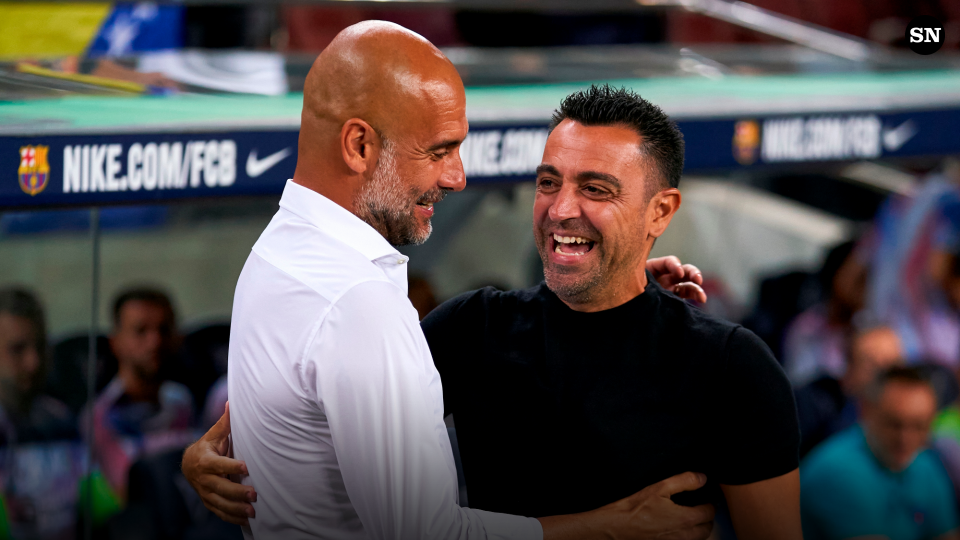 Pep Guardiola of Man City and Xavi of Barcelona