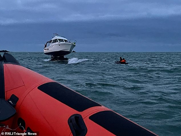 Attempts to rescue the crew on board the stricken boat took 12 hours as, during the rescue, the tide went out leaving the motor cruiser stranded on a rock 10ft above the water