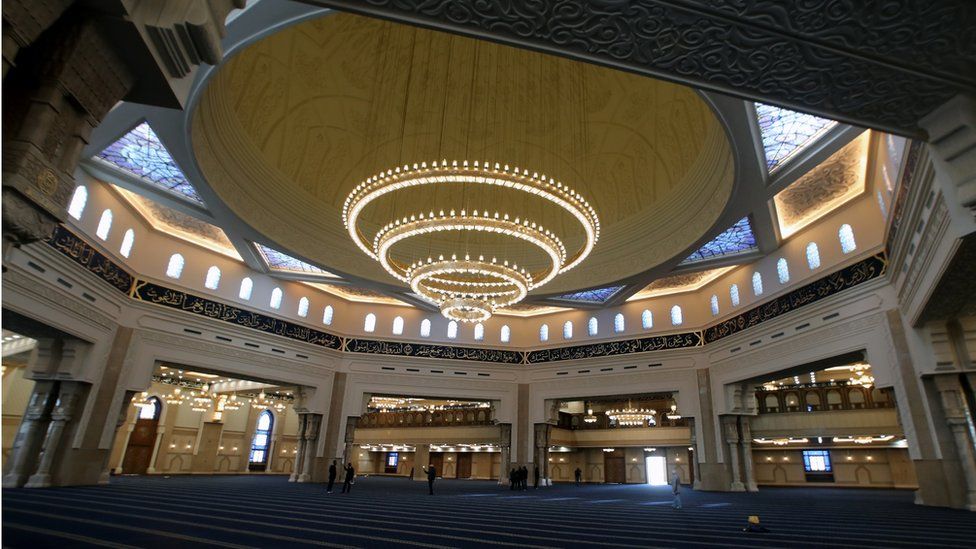 Laborers work inside the newly-constructed Al-Fattah Al-Alim mosque at the new administrative capital, 45km east of Cairo,