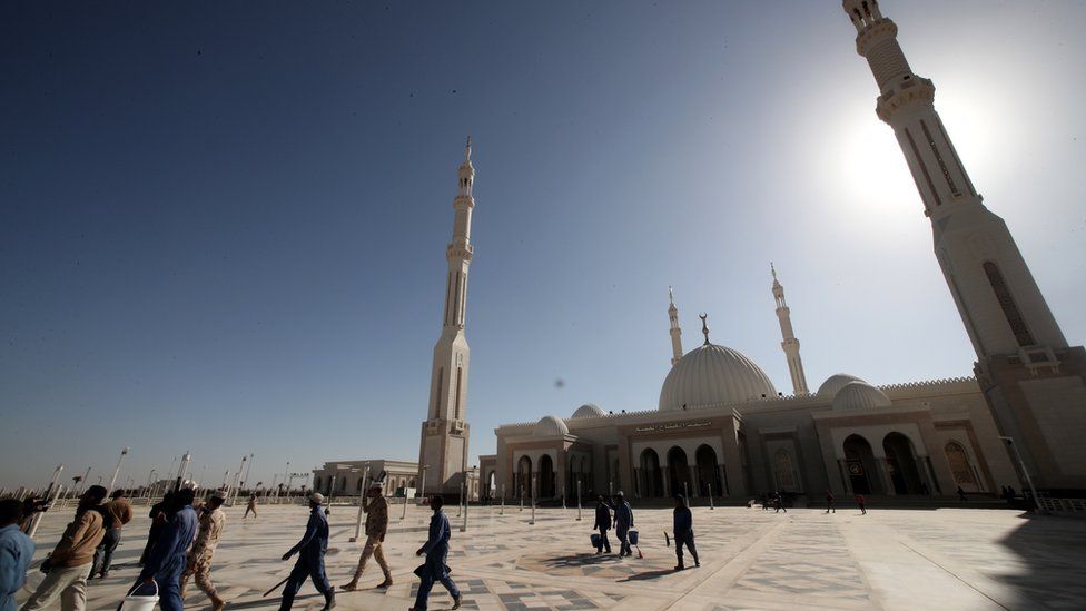 Labourers work outside the newly-constructed Al-Fattah Al-Alim mosque at the new administrative capital, 45km east of Cairo