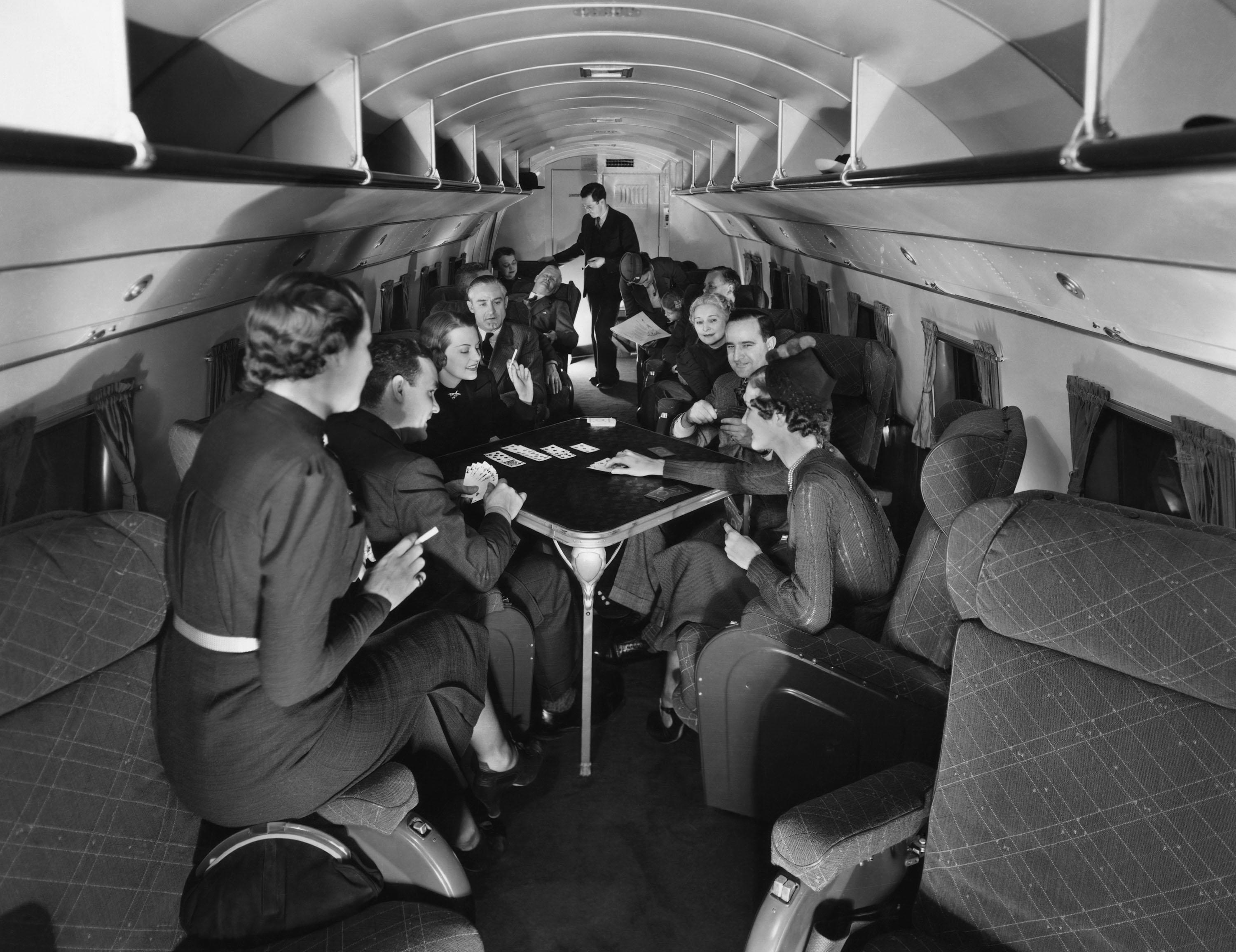 Passengers play cards on United Airline's Skylounge Mainliner in 1937