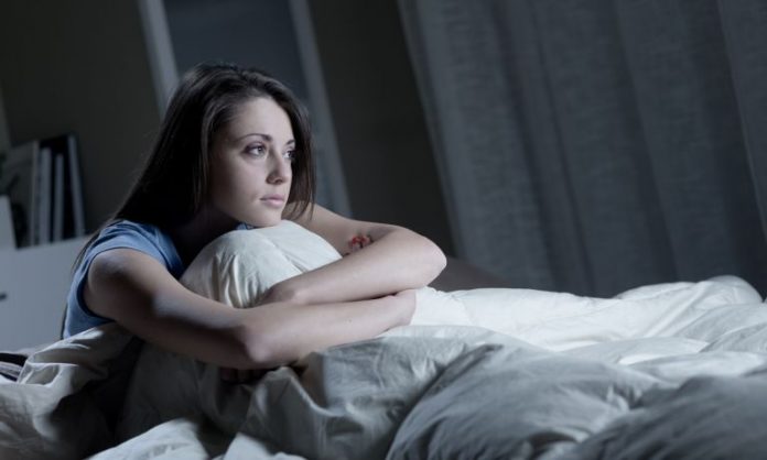 woman-staring-out-from-bed-768