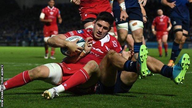 Tomas Lezana of Scarlets dives over to score his side's second try despite the tackle of Josh van der Flier of Leinster