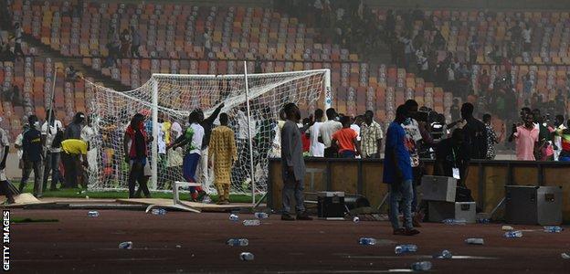 A pitch invasion at the Moshood Abiola National Stadium in Abuja