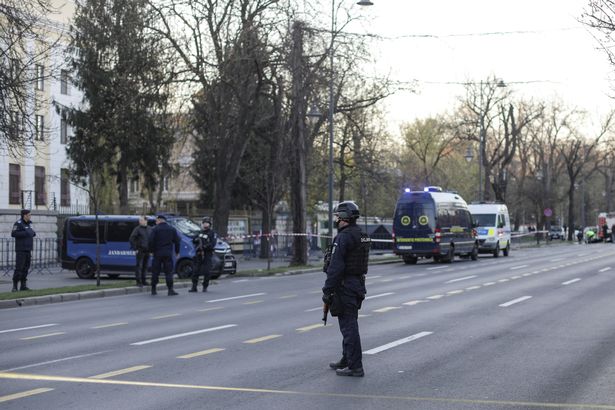 0_A-man-crashed-his-car-in-the-gate-of-the-Russian-Embassy-in-Bucharest Police officers stand guard of the crime scene in Bucharest, Romania, outside the Russian embassy ( Image: REUTERS)