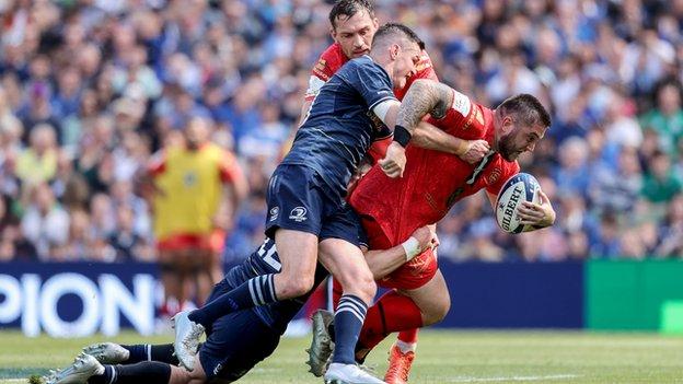 Leinster pair Robbie Henshaw and Johnny Sexton tackle Toulouse prop Cyril Baille