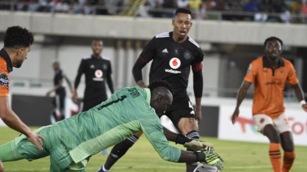 Orlando Pirates goalkeeper Richard Ofori dives to stop the ball during the Confederation Cup final between South Africa's Orlando Pirates and RS Berkane of Morocco in Uyo, Nigeria