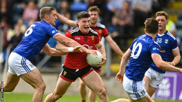 Cavan defender Killian Clarke tackles Down's Daniel McGuinness in the Tailteann Cup opener