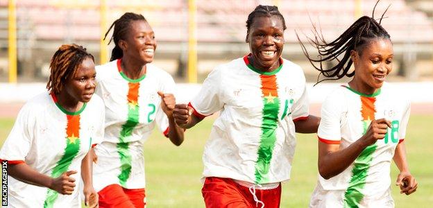 Burkina Faso players celebrate a goal by Juliette Nana (far right)
