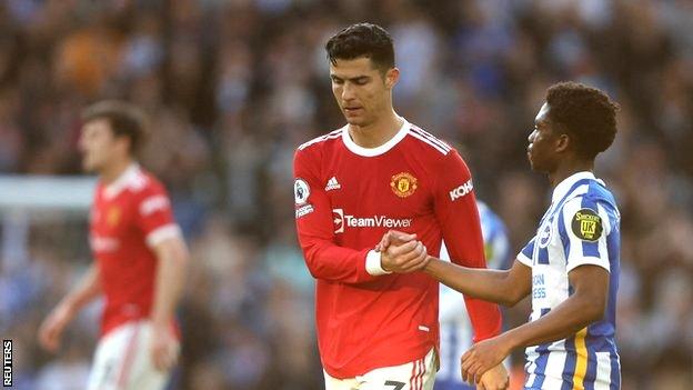 Manchester United's Cristiano Ronaldo shakes hands with Brighton & Hove Albion's Tariq Lamptey