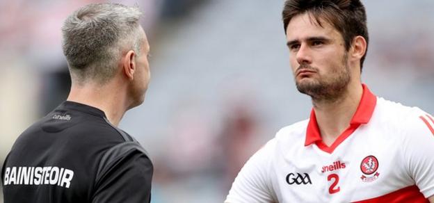 Oak Leaf boss Rory Gallagher consoles Derry skipper Chrissy McKaigue after the team's heavy defeat in Croke Park
