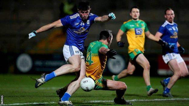 Cavan's James Smith gets in a shot despite Michael Murphy's best efforts in the 2020 Ulster Final
