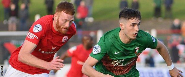 Larne's Cian Bolger in action against Glentoran forward Jay Donnelly
