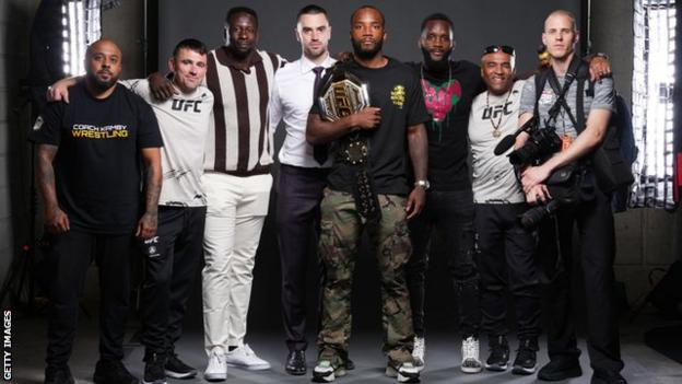 Leon Edwards poses with his team with his UFC belt