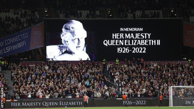 The LED board shows a photo Queen Elizabeth II as players of West Ham United and FCSB observe a minutes silence