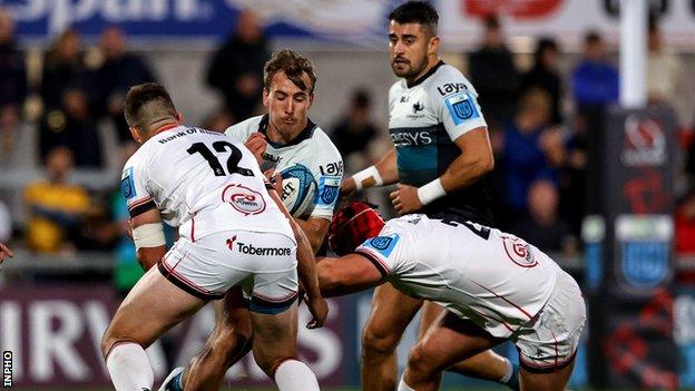 John Porch is tackled by Stuart McCloskey and Tom Stewart