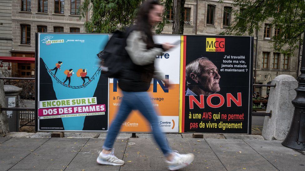 Man walks past campaign posters
