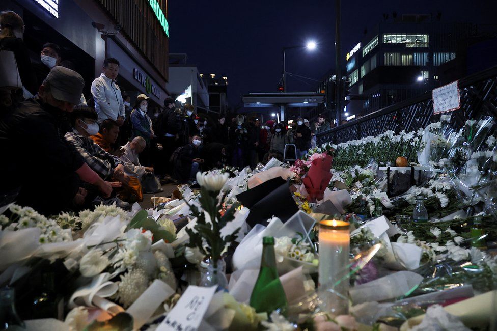 People pay their respects near the scene of a crowd crush that happened during Halloween festivities, in Seoul, South Korea, October 31, 2022.