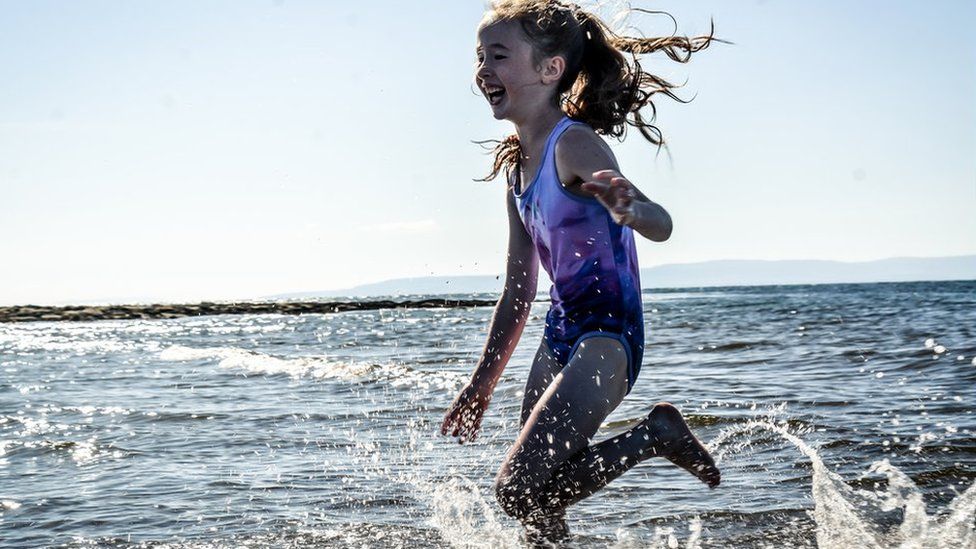 Girl splashing in seawater