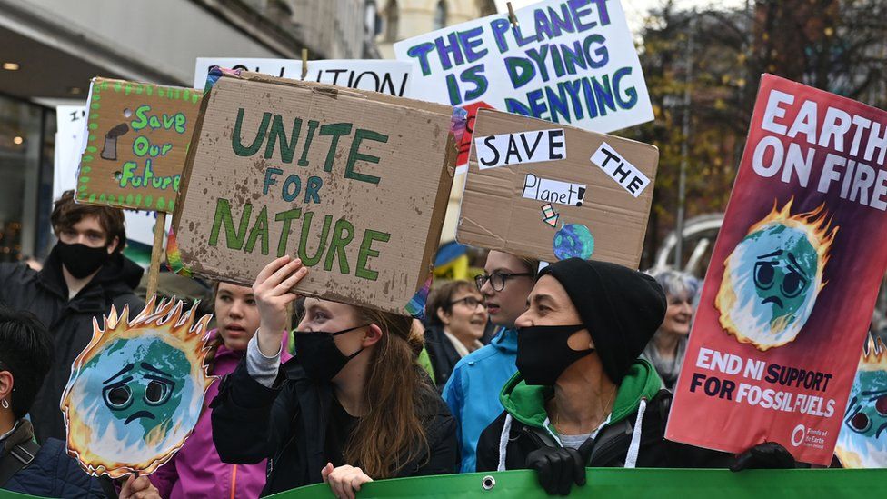 Protesters chant and hold placards at the climate change rally in Belfast in November 2021