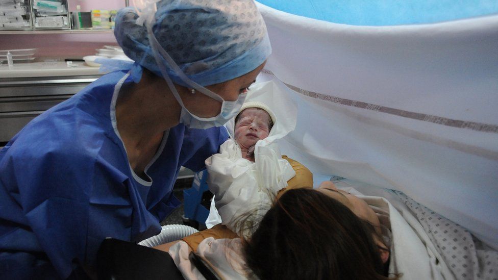 Baby, mum and midwife after c-section