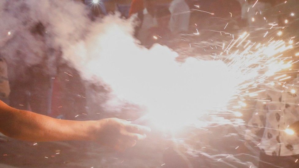 Person holding firework (generic)