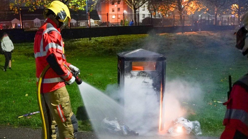 firefighter extinguished fire by bin