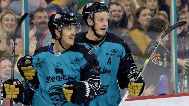 Steve Owre (left) celebrates with Mark Cooper after notching one of his four goals in the 9-3 hammering of Cardiff Devils
