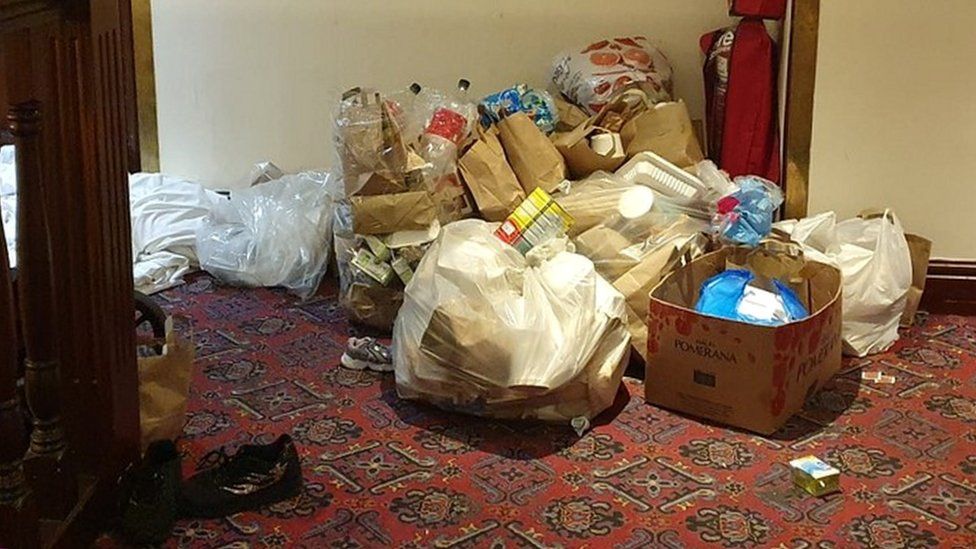 Piles of rubbish in hotel hallway