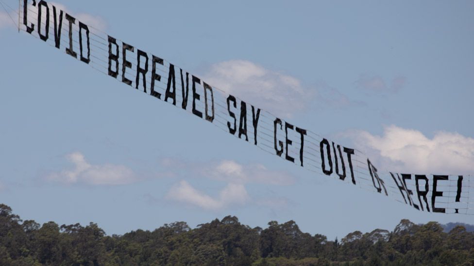 Airborne banner reading "Covid bereaved say get out of here!"