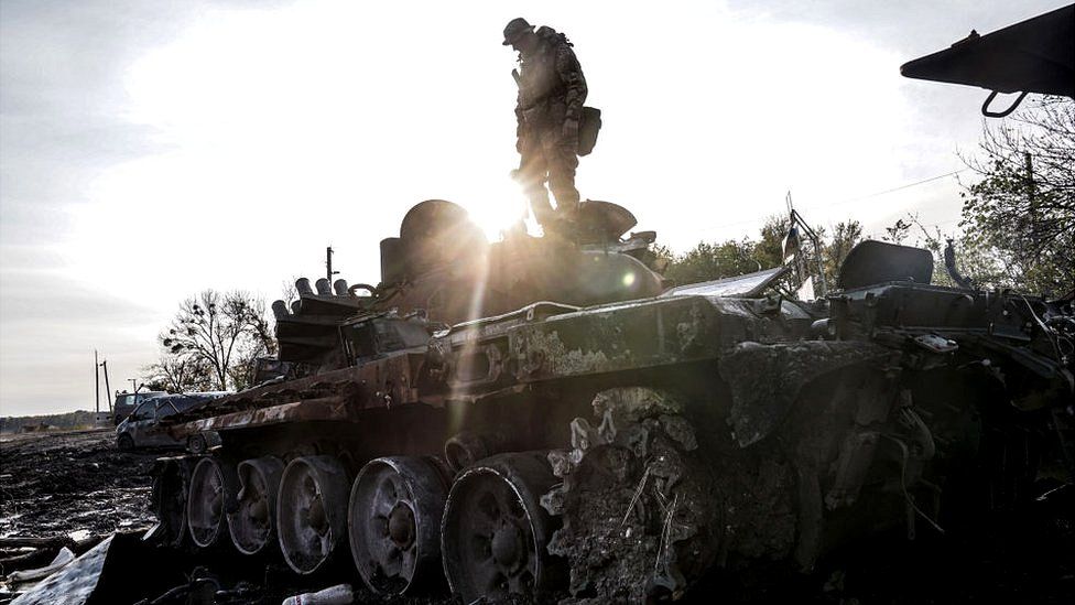 Ukrainian military man inspects a destroyed Russian tank near the city on October 1, 2022 in Sviatohirsk