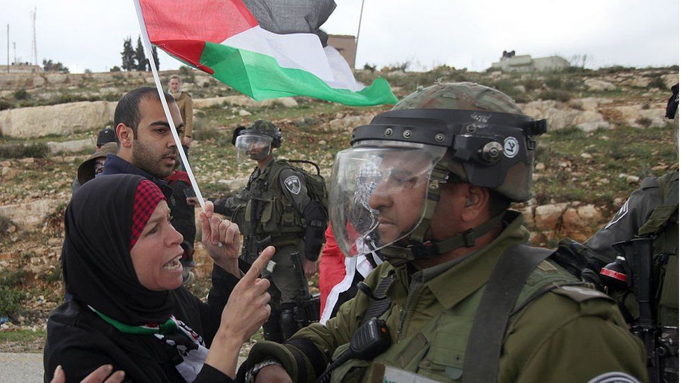 Palestinian woman confronts Israeli soldier in the West Bank (file photo)