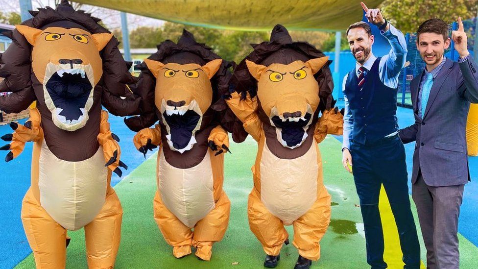 School teacher with Gareth Southgate cut-out and inflatable lions